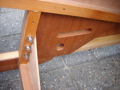 The cover over the multiple parts that fill the area just behind the place where the landinggear will run. The two holes in it are for steering control parts. Also visible is that fourth transversal stick under the seat. It does not support the seat. Part 33 is that vertical stick that holds the bolts. Parts 51 and 52 are glued to it. Figure 121 and 124.
